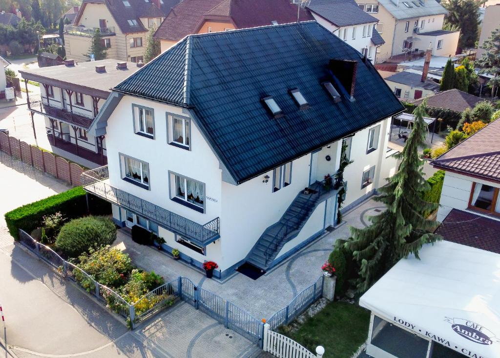 an overhead view of a white house with a blue roof at MM Pokoje in Dziwnówek