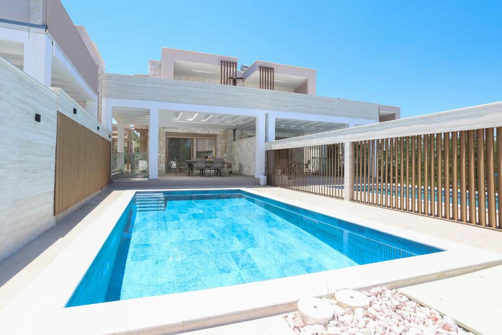 a swimming pool in the backyard of a house at The Serata Villas in Hanioti
