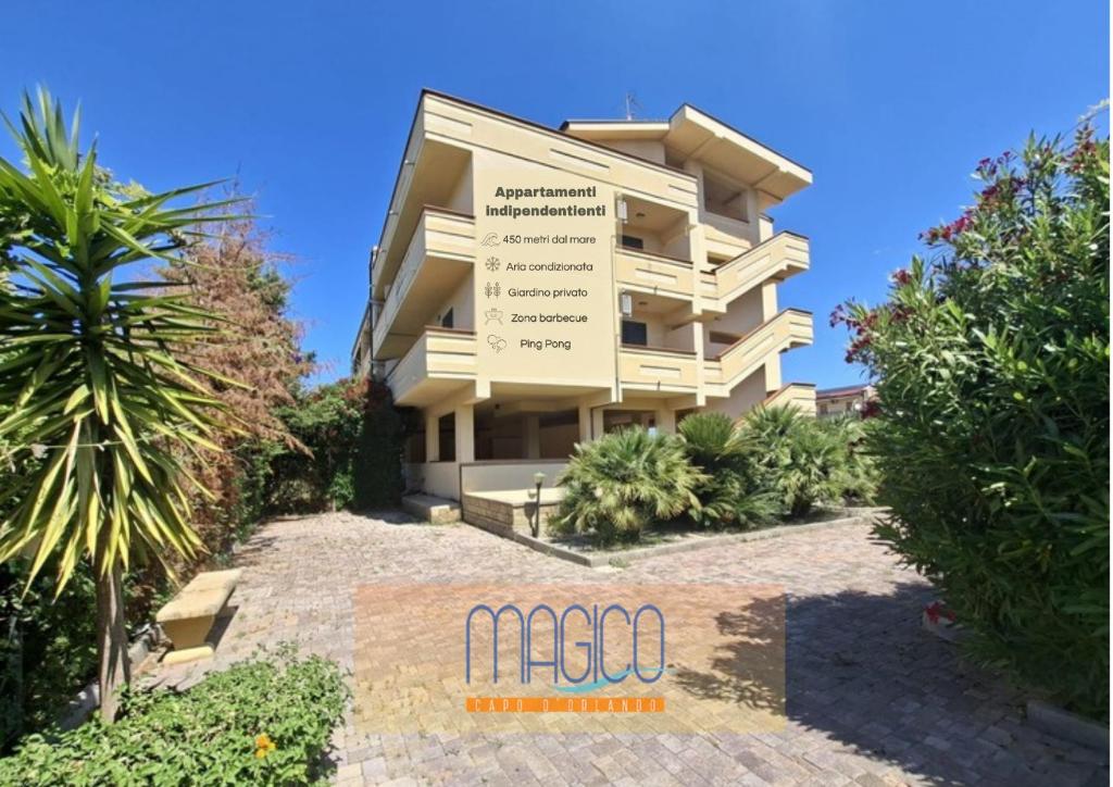 a building with a sign in front of it at Magico Apartments - 450m dalla spiaggia in Capo dʼOrlando