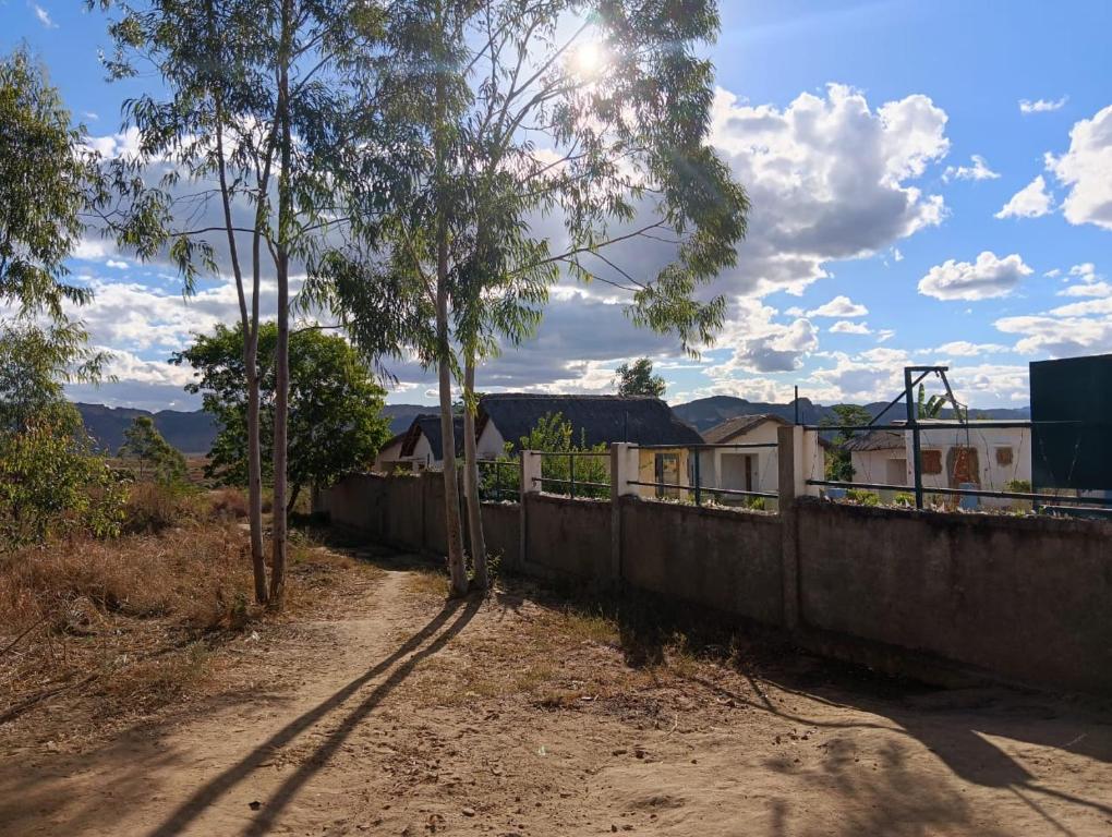 a dirt road next to a wall and trees at FG Bungalow Bar in Ianakandrarezo