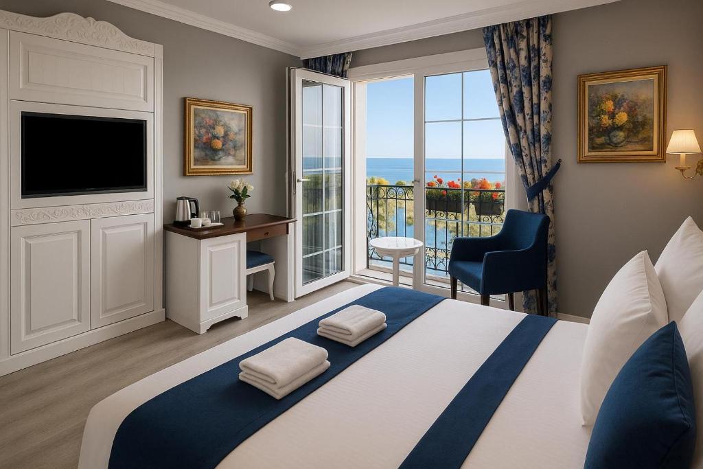a bedroom with a large bed with a large window at Sahil Panorama Otel in Trabzon