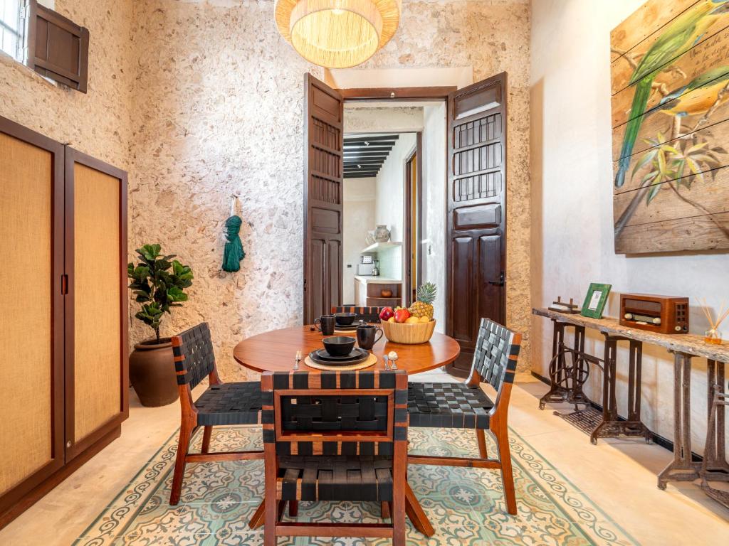 a dining room with a table and chairs at Casa Bolero Santa Lucía with Parking by Cercana in Mérida