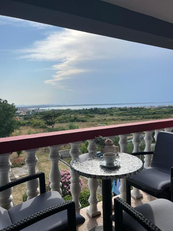 a table on a balcony with a view of the ocean at Lydia in Vrsi