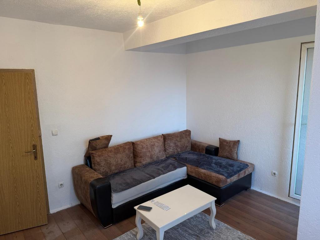 a living room with a couch and a table at Ring Urban Apartment in Kosovo Polje