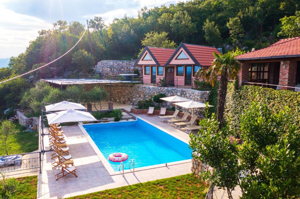 a house with a swimming pool in a yard at Peuta Hill in Podgorica