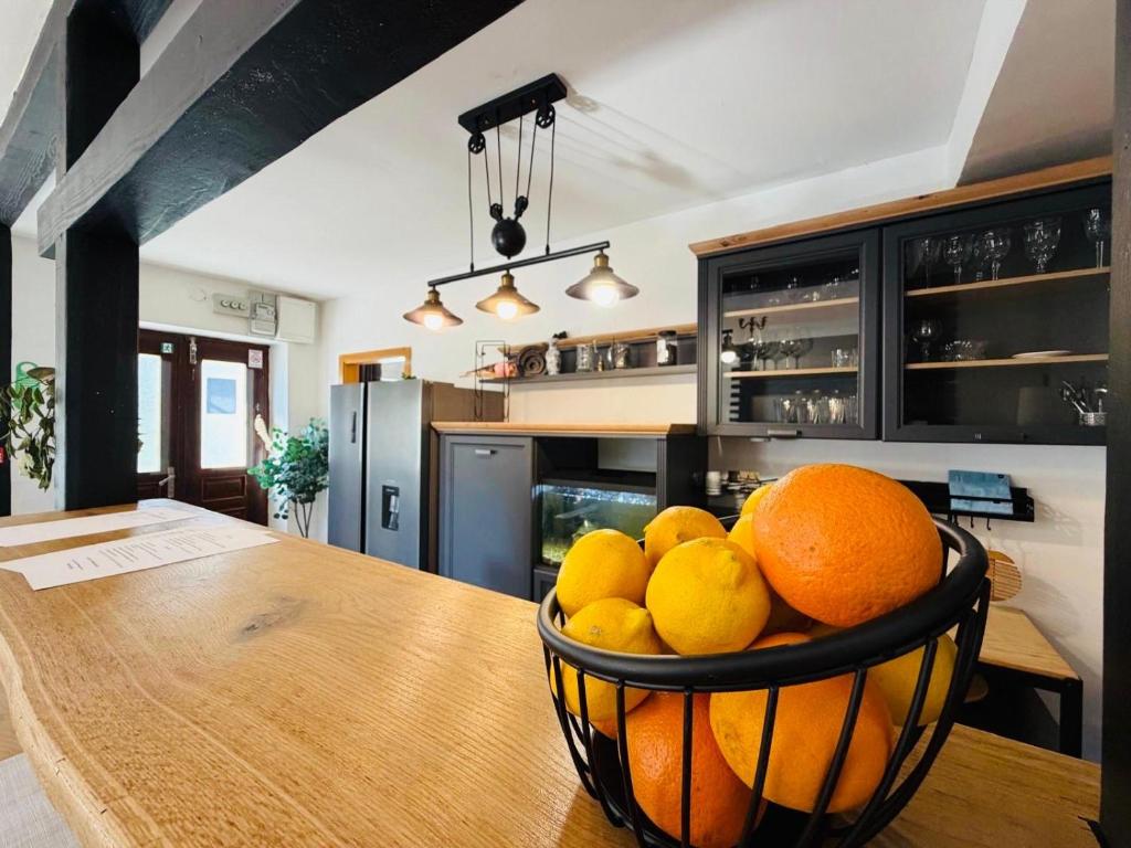 a bowl of oranges on a table in a kitchen at Villa GoldenPearl in Povile