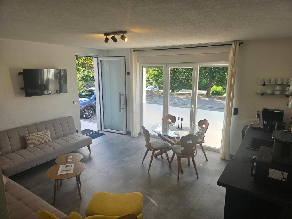a living room with a couch and a table and chairs at Ferienwohnung Zur Alt Ave in Deggingen
