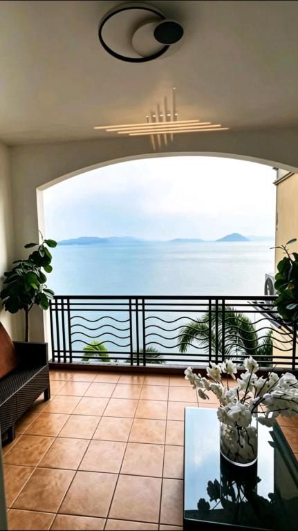 a room with a balcony with a view of the ocean at Club Balai Isabel Front Taal Lake & Volcano View in Talisay