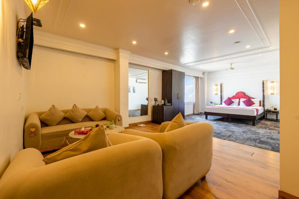 a living room with two couches and a bed at The Saga Hotel Green Park in New Delhi