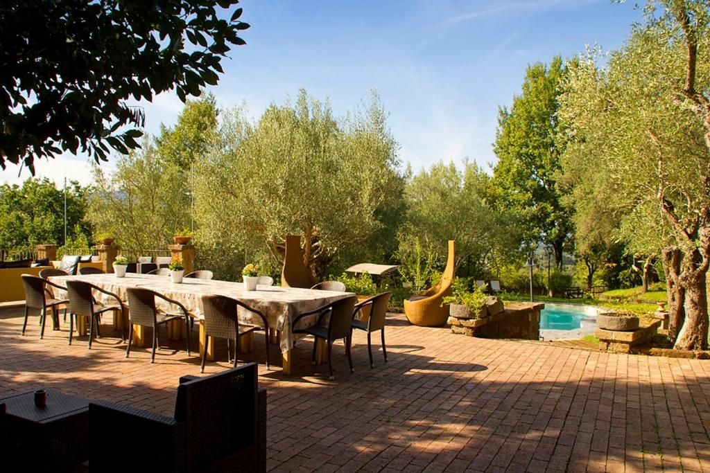 a table and chairs sitting on a brick patio at La Corte di Maria in Piccilli