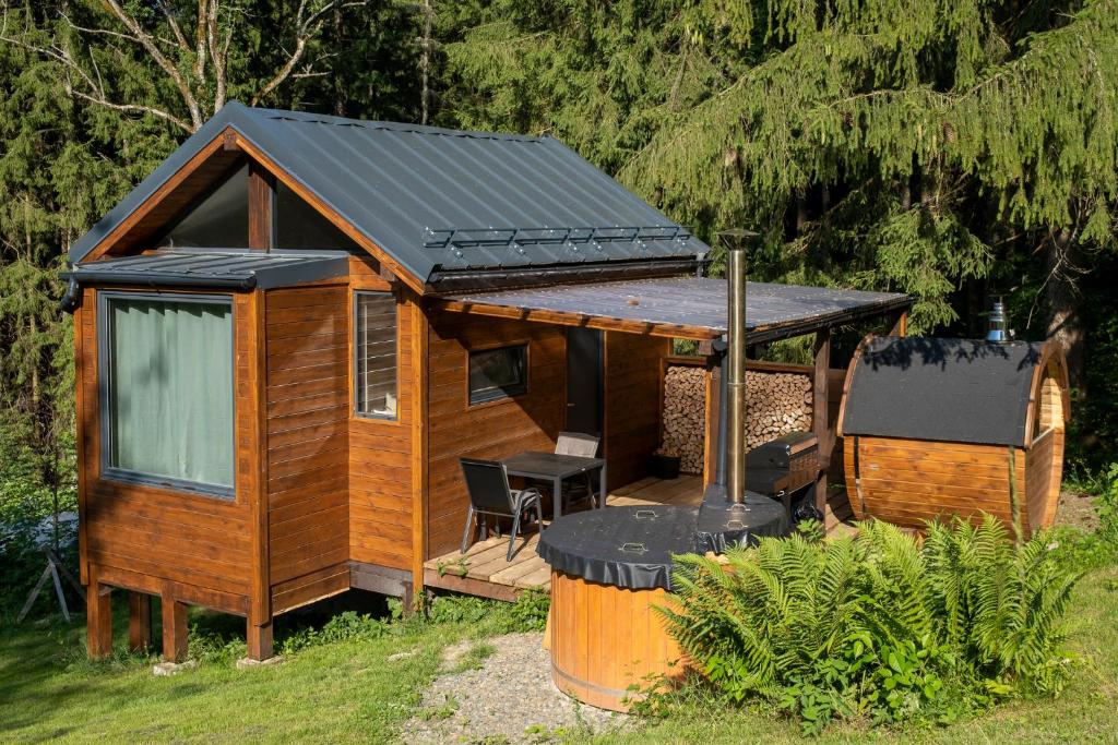 a cabin with a solar roof on a deck at Glamping Walden in Nový Hrozenkov