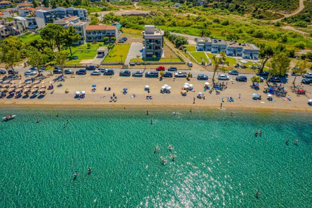 an aerial view of a beach with people and umbrellas at Filian Apartments in Neos Marmaras