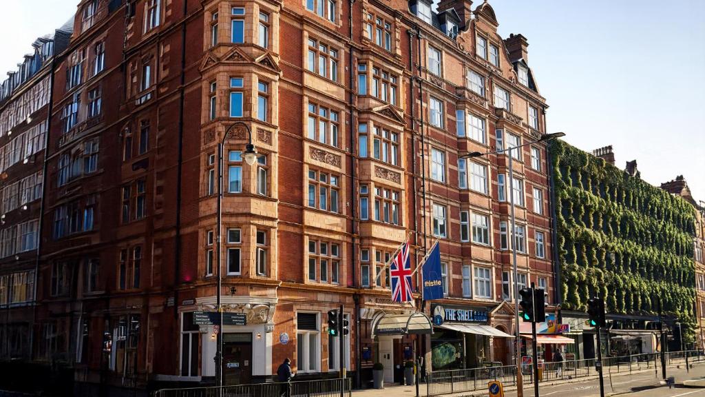 a large red brick building on a city street at Thistle London Bloomsbury Park in London
