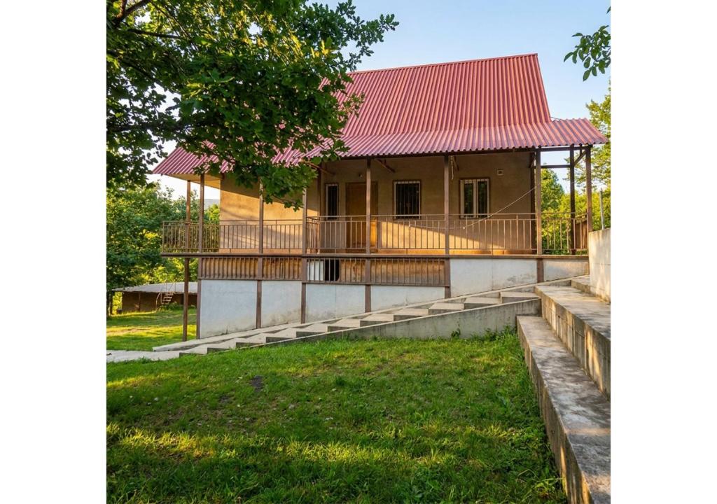 a house with a red roof and a yard at Forest Edge Guesthouse in Aghavnadzor
