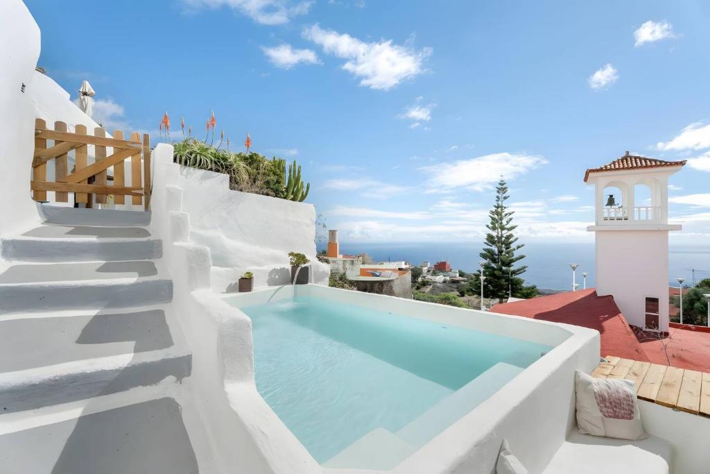a pool on the side of a house with a view at Cueva Sol in Fasnia
