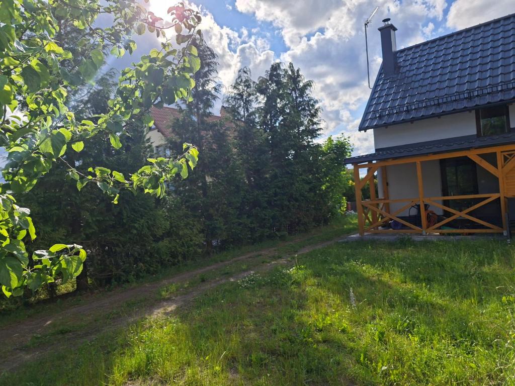 a house with smoke coming out of it at Dom Trakt Słupski Sulęczyno in Sulęczyno