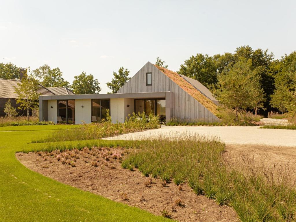 a house with a garden in front of it at Villa WOOD in Elsendorp