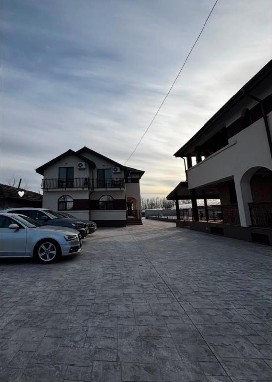 a car parked in a parking lot next to a building at Complexul Profestur in Valea Dragului