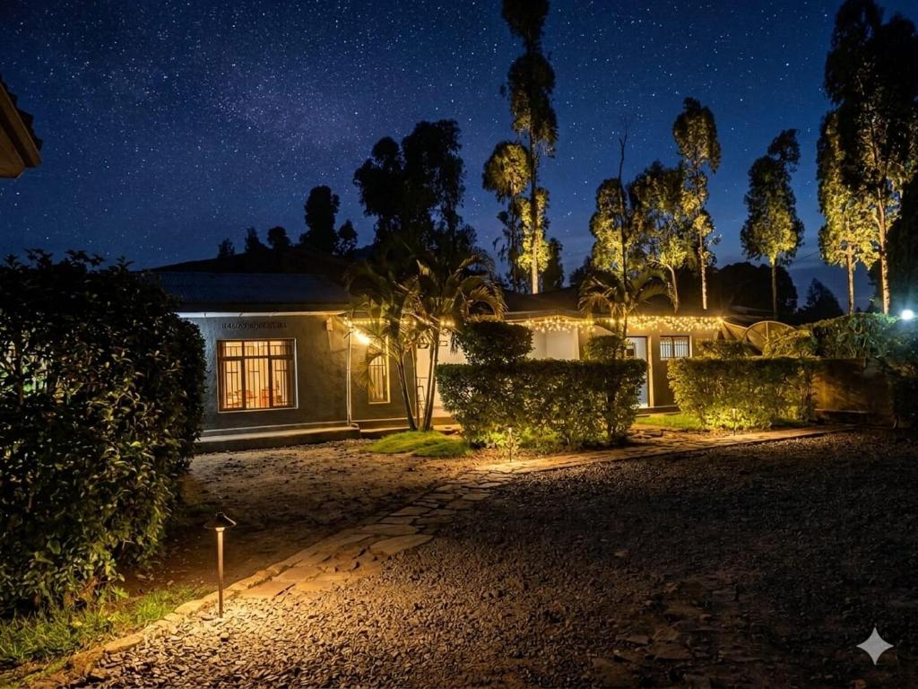 a house at night with the lights on at Amare Guest House in Cyuve