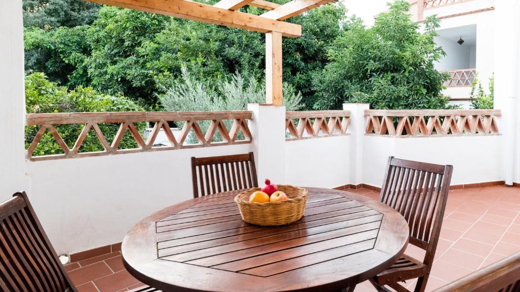 a wooden table with a basket of fruit on a patio at Alpujarra Relax with Terrace in Órgiva