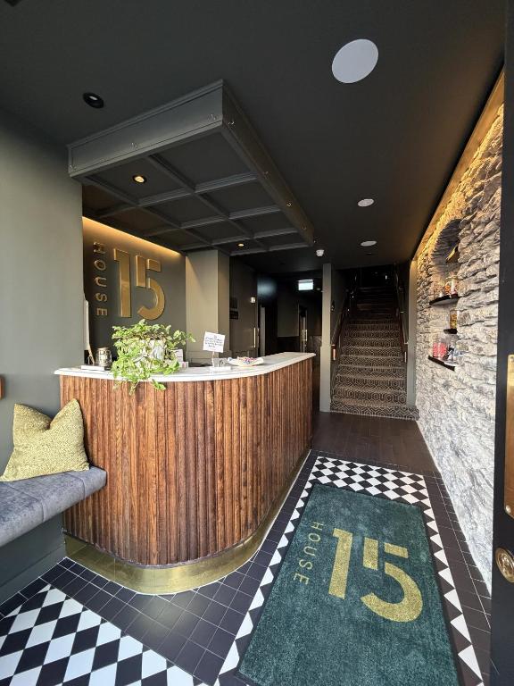 a hotel lobby with a reception counter and stairs at House 15 in Kenmare