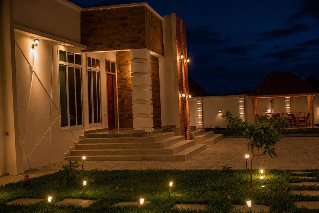 a house with lights in the yard at night at ExtraMile Apartments - 2BR-R in Dodoma