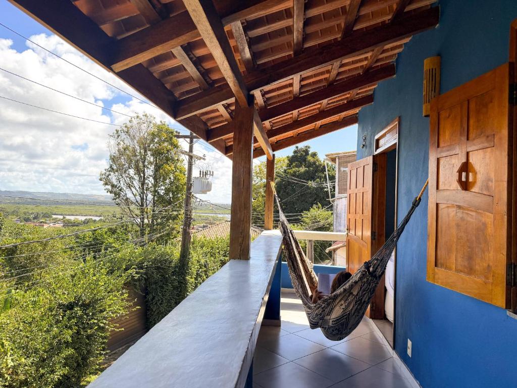a hammock on the porch of a house at Casa Magna in Itacaré