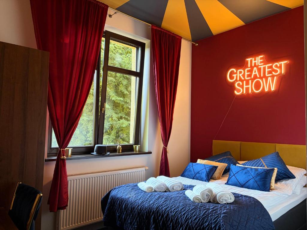 a bedroom with a bed with a sign that says the greatest show at La Melodia in Kościerzyna