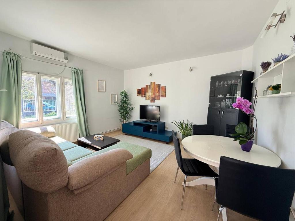 a living room with a couch and a table at Moon Stylish -FREE parking -Romantic City Stay in Timişoara