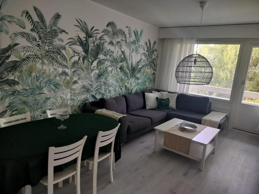 a living room with a couch and a table at Gran Palmu in Pori