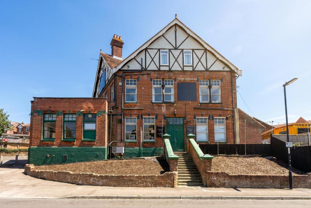an old brick building with a green door at The Bitterne Park Hotel in Southampton