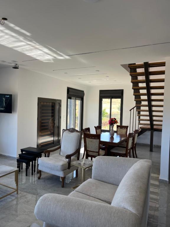 a living room with a couch and chairs and a table at زهرة الخليج in Jerash