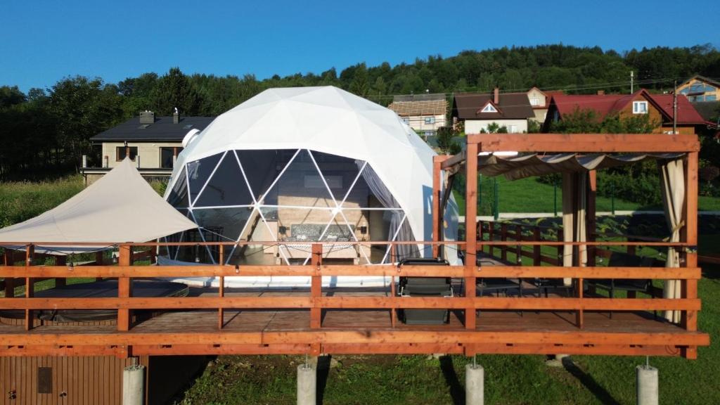 a yurt on a wooden deck with a fence at MB Glamp in Międzybrodzie Bialskie