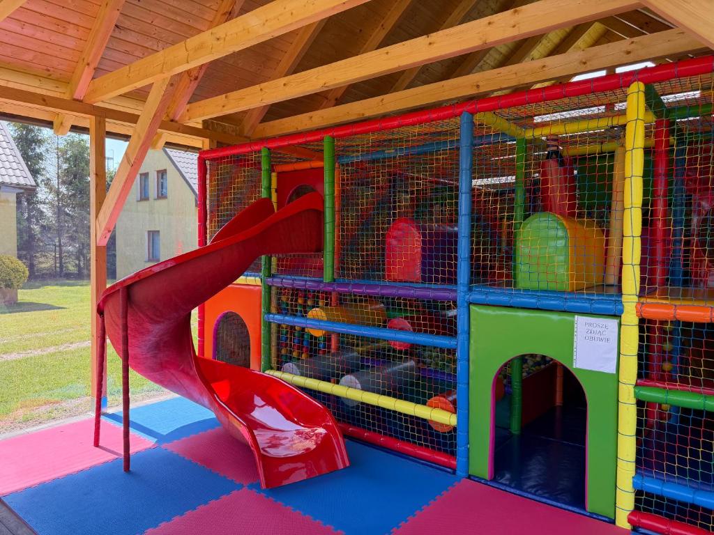 a playground with a slide and a play house at Domki Ania in Łeba