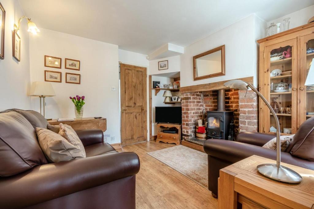 a living room with a couch and a fireplace at 2 Bed in Richards Castle oc-r45225 in Lane to Richards Castle