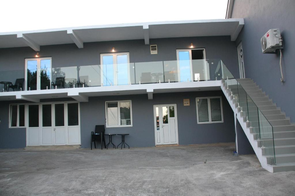 a building with a staircase on the side of it at B-I Apartmani in Glavatske Kućice