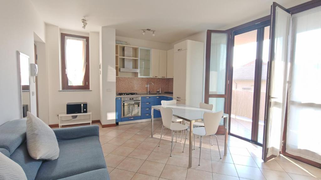 a living room with a couch and a table and chairs at JENNAH House in Bussero
