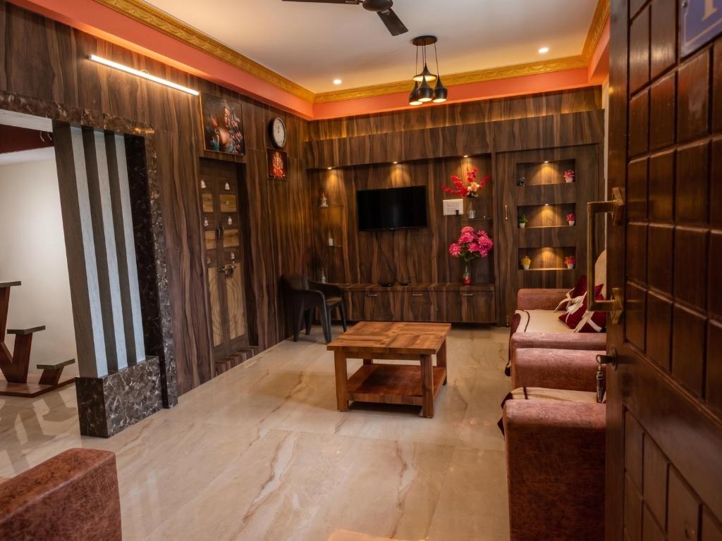 a living room with a couch and a table at SVL HomeStay in Chik Ballāpur