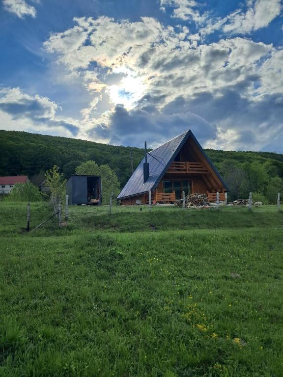 a log cabin in the middle of a field at Suvi Vrh mountain cabin in Gacko