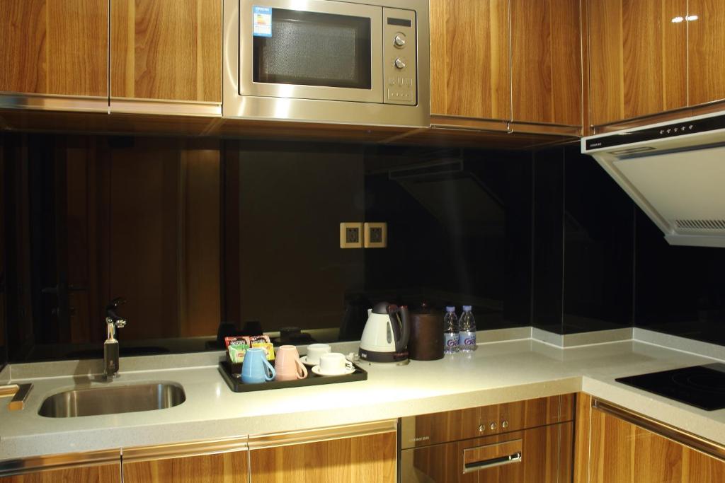 Kuchyň nebo kuchyňský kout v ubytování Sentosa Hotel Apartment Taoyuan Branch