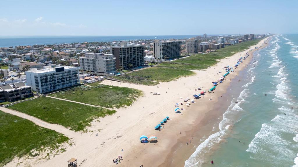 an overhead view of a beach with people and umbrellas at Beachfront 2BR 5th Floor Views Wakable SPI in South Padre Island