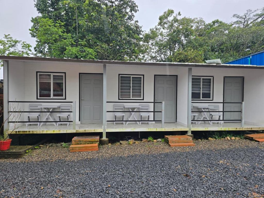 a small house with three windows and a porch at EcoHotel Farallones in San Pedro de Jagua