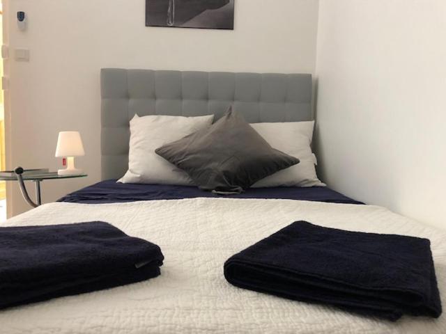a bed with two towels on top of it at Cosy studio au centre ville in Perpignan
