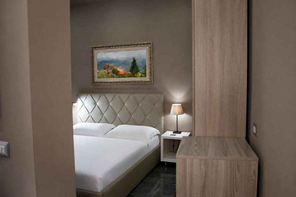 a bedroom with a bed and a picture on the wall at KAIROS - Centro di Oliveto Citra in Oliveto Citra