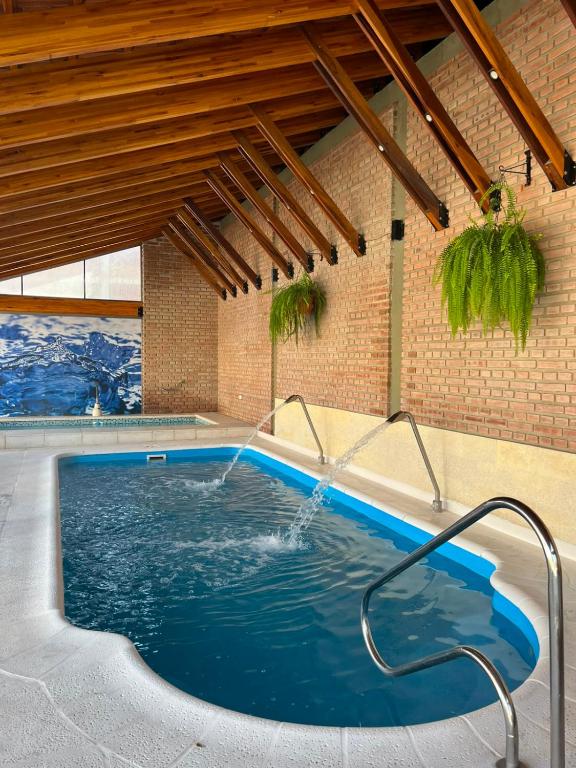 a large swimming pool in a building with a swimming pool at Riviera Hotel & Spa in Villa Carlos Paz