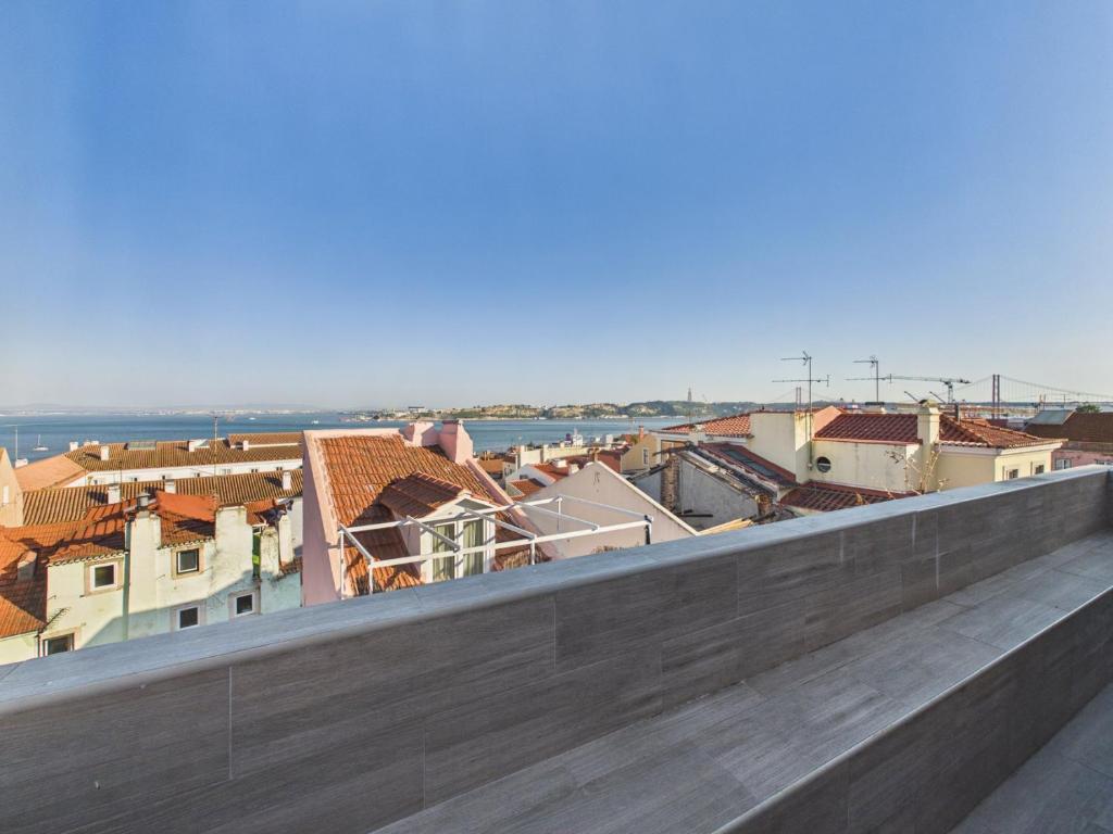a view of a city from the roof of a building at 2BR Terrace with Tagus View - Air-Conditioned | By Airnest in Lisbon