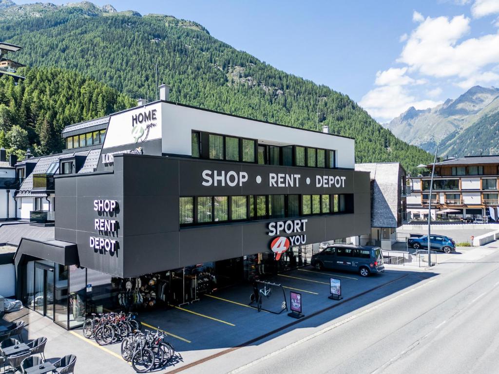 a building with bikes parked in a parking lot at Home4You in Sölden
