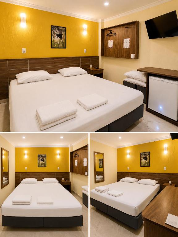a bedroom with two beds and a flat screen tv at Hotel Villa Rica in Rio de Janeiro