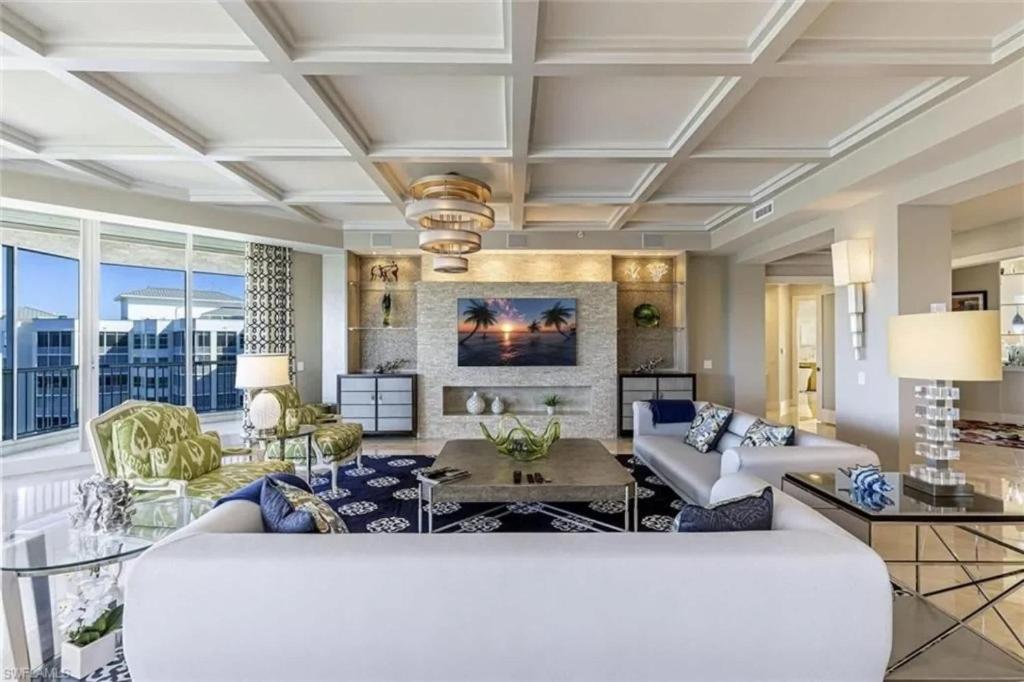 a living room with a large white couch at Grande Vista Retreat in Naples