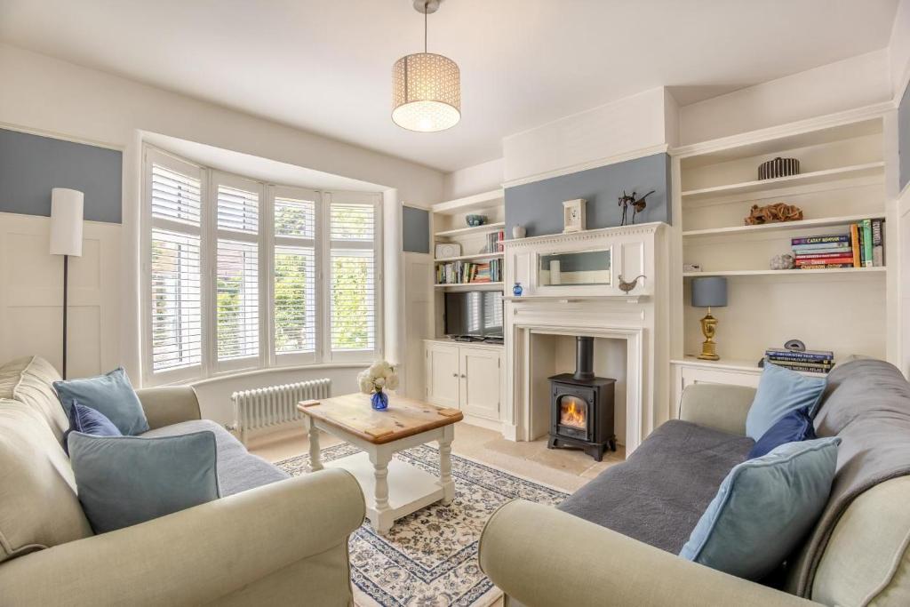 a living room with two couches and a fireplace at 3 Bed in Reydon oc-brae in Reydon